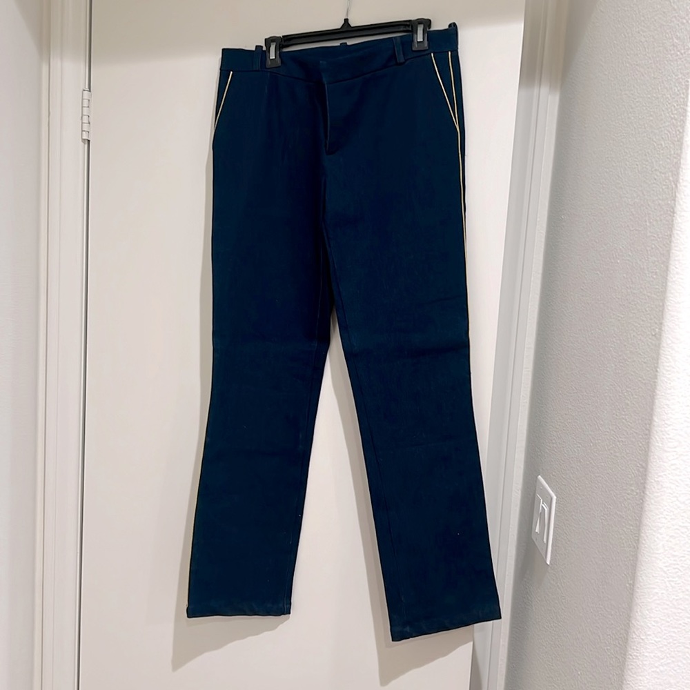 Dark denim with gold trim jeans. Used, excellent condition.